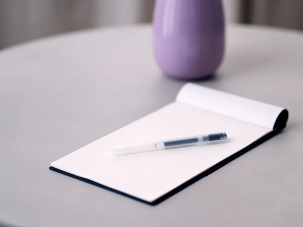 Notizblock und Vase in der Praxis Dalpas Frankfurt – Symbol für unsere strukturierte und ruhige Arbeitsweise